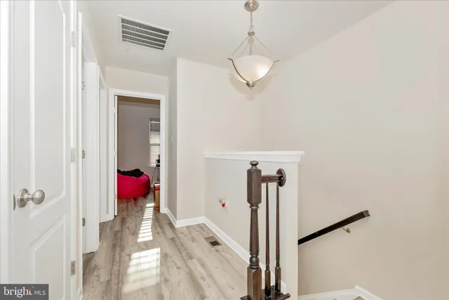 a view of a room with wooden floor closet and windows