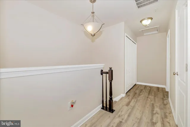 a view of a room with wooden floor