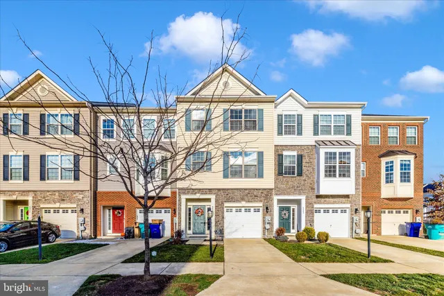 a front view of a residential apartment building with a yard