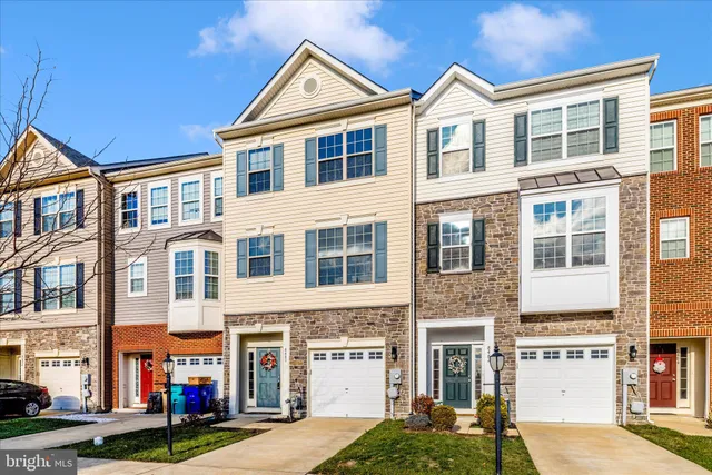 a front view of a residential apartment building with a yard