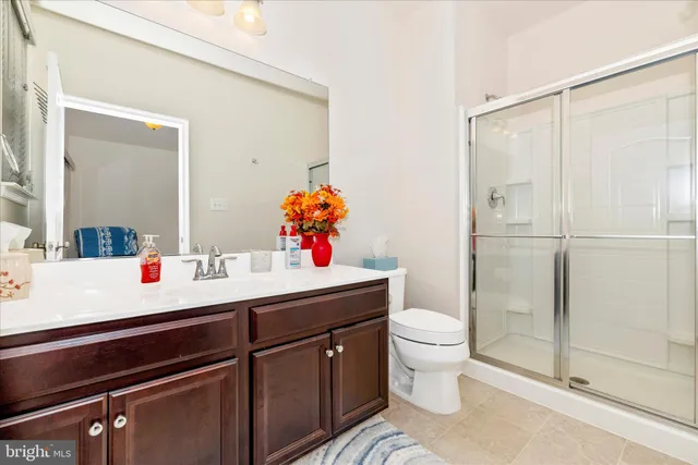 a bathroom with a sink vanity mirror and toilet