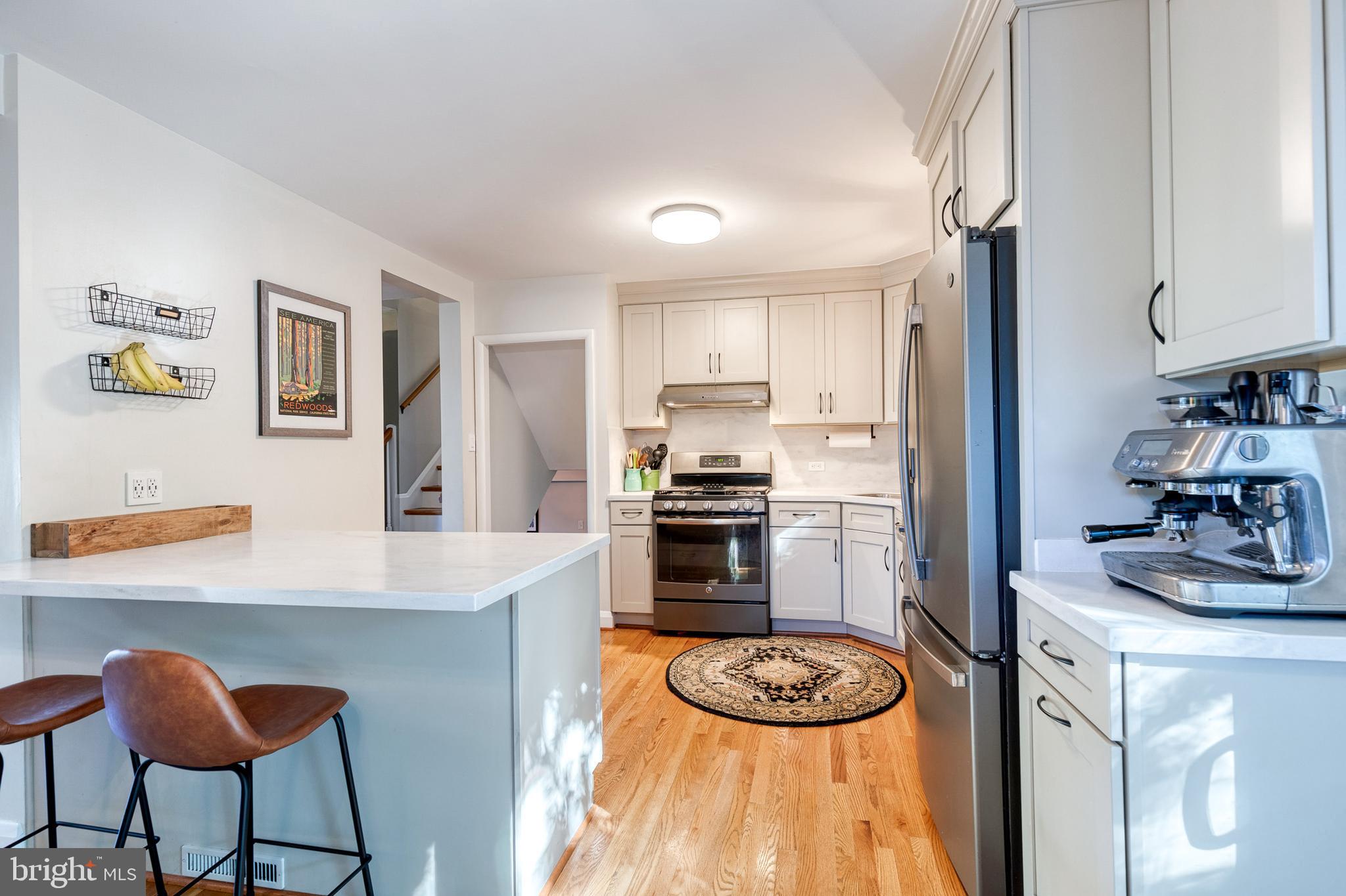 1 North Hilltop Road Baltimore, MD 21228 - Photo 15 of 36 a kitchen with a refrigerator and a stove top oven