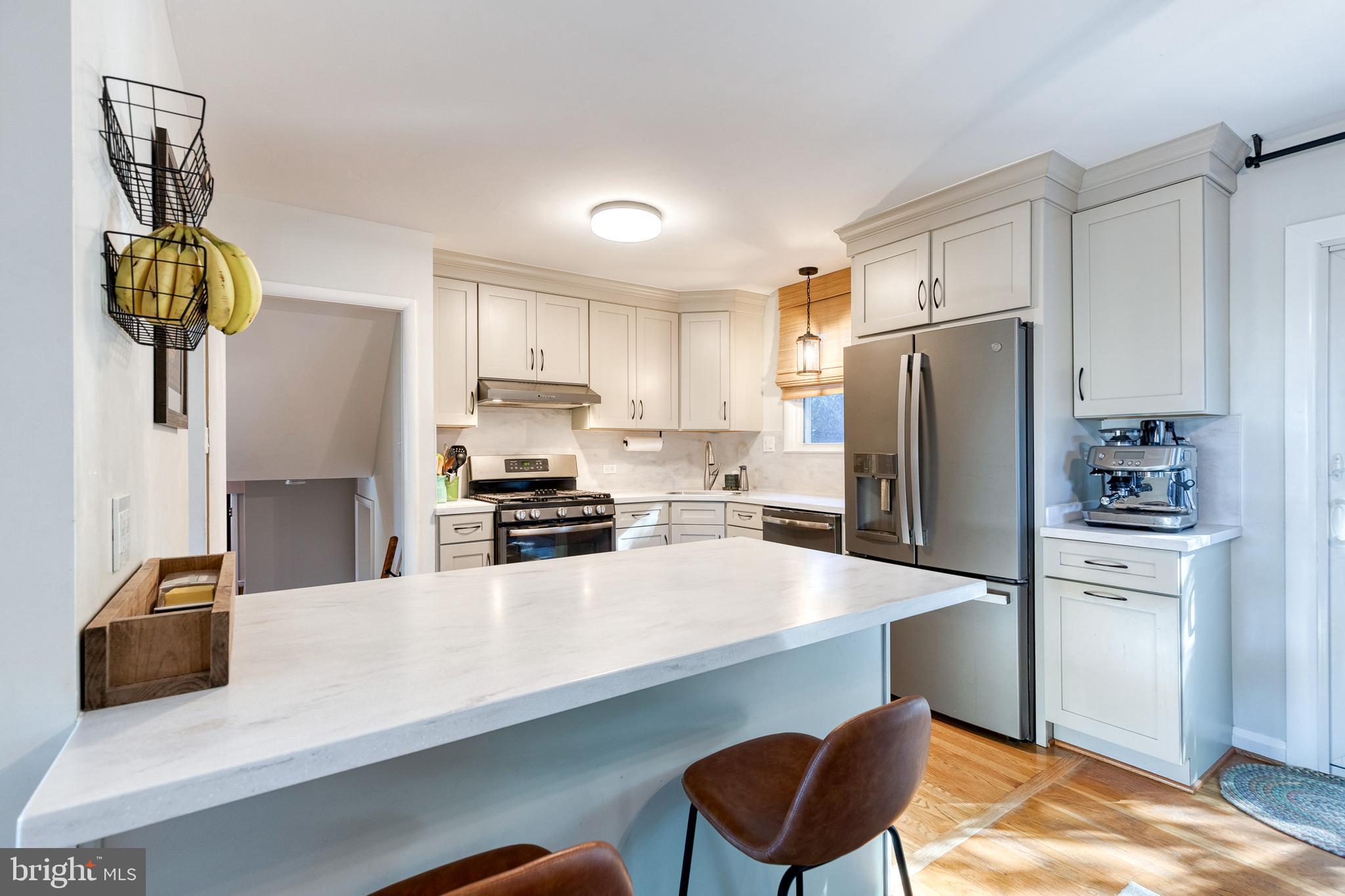 1 North Hilltop Road Baltimore, MD 21228 - Photo 16 of 36 a kitchen with stainless steel appliances a refrigerator a sink a stove and chairs