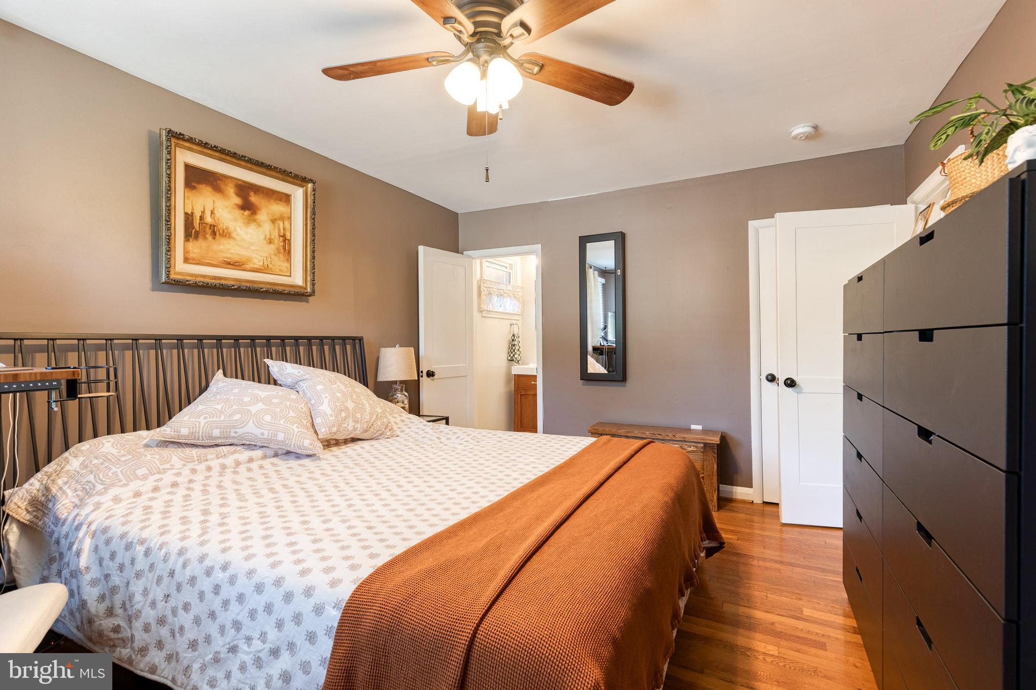 1 North Hilltop Road Baltimore, MD 21228 - Photo 21 of 36 a bedroom with a large bed and a chandelier