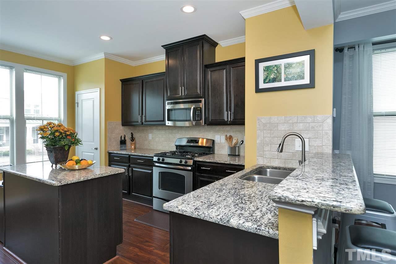 5639 Wade Park Boulevard Raleigh, NC 27607 - Photo 2 of 24 a kitchen with stainless steel appliances granite countertop a stove and a sink