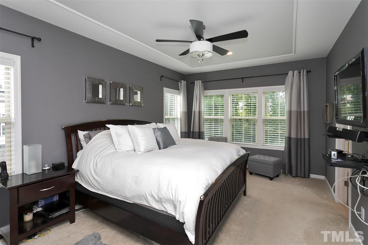 5639 Wade Park Boulevard Raleigh, NC 27607 - Photo 12 of 24 a large bed sitting in a bedroom next to a window