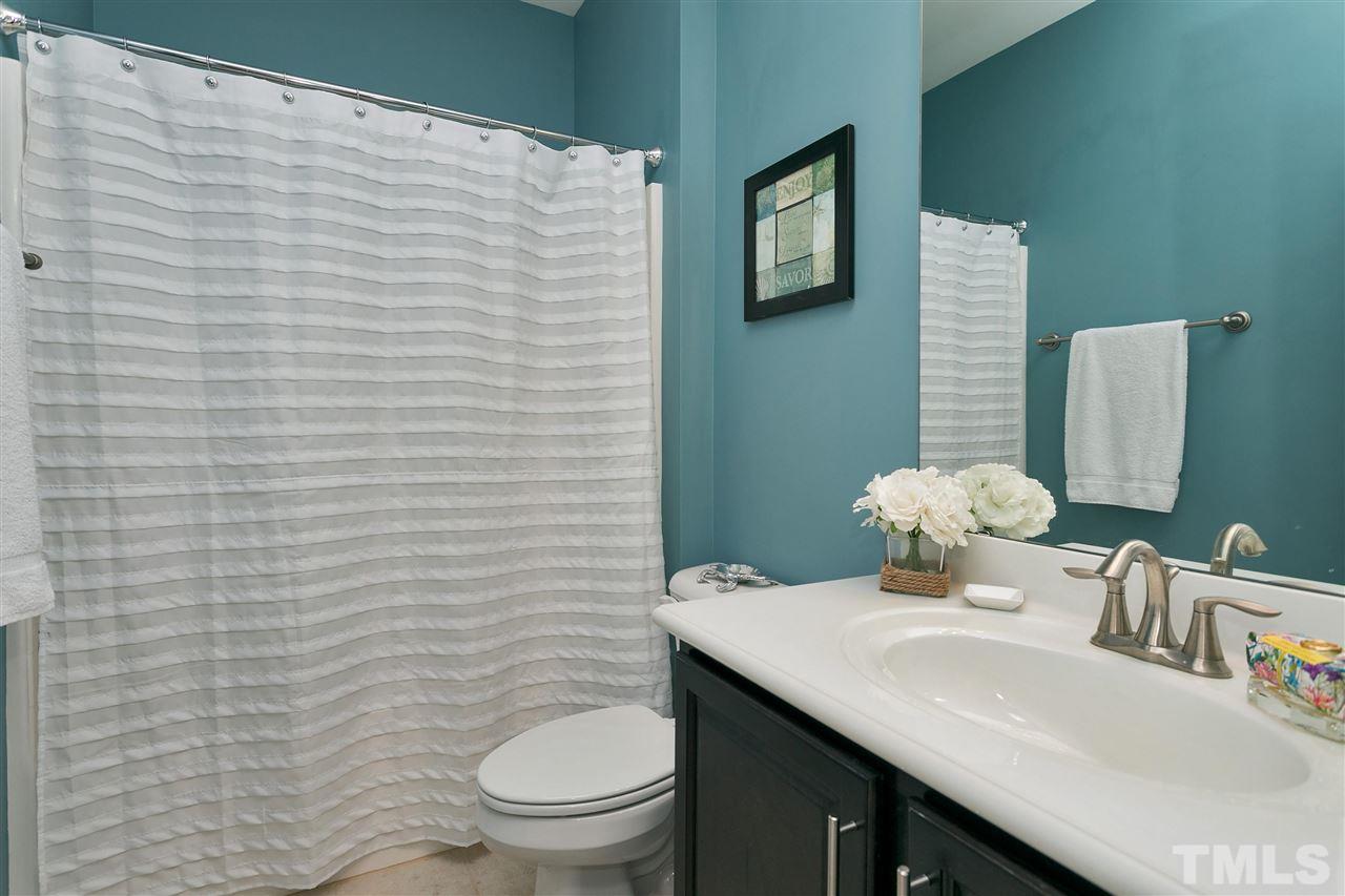 5639 Wade Park Boulevard Raleigh, NC 27607 - Photo 18 of 24 a bathroom with a sink a toilet and mirror