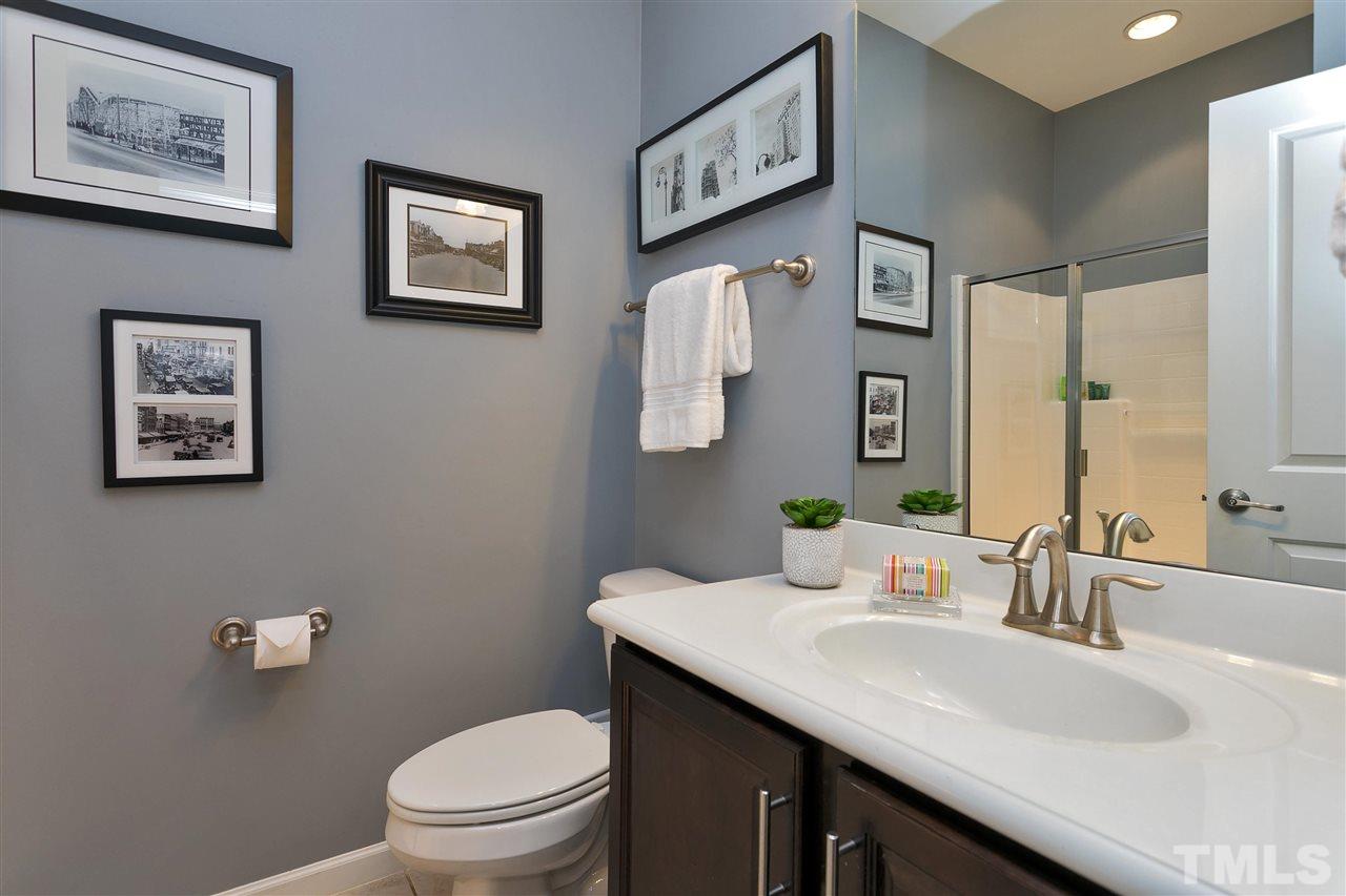 5639 Wade Park Boulevard Raleigh, NC 27607 - Photo 20 of 24 a bathroom with a granite countertop sink mirror vanity and toilet