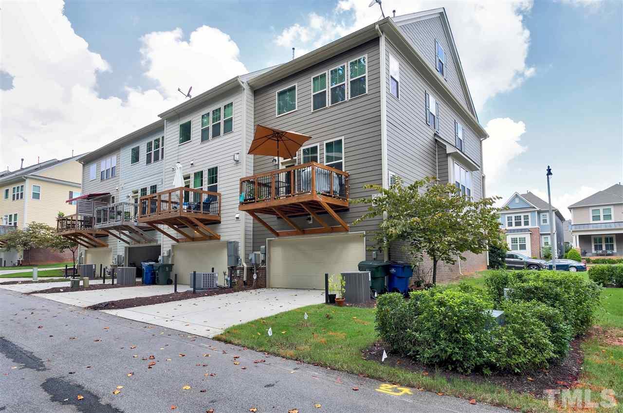 5639 Wade Park Boulevard Raleigh, NC 27607 - Photo 21 of 24 a front view of a building with a garden and plants