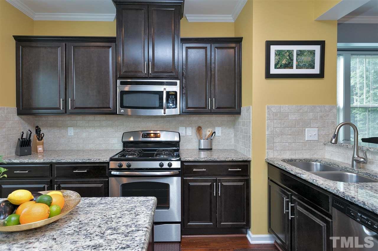 5639 Wade Park Boulevard Raleigh, NC 27607 - Photo 6 of 24 a kitchen with a sink and a stove top oven