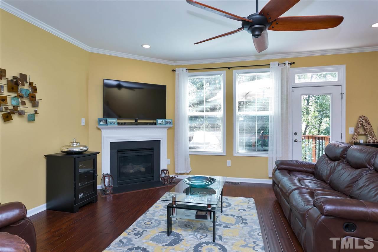 5639 Wade Park Boulevard Raleigh, NC 27607 - Photo 10 of 24 a living room with furniture a fireplace and a flat screen tv