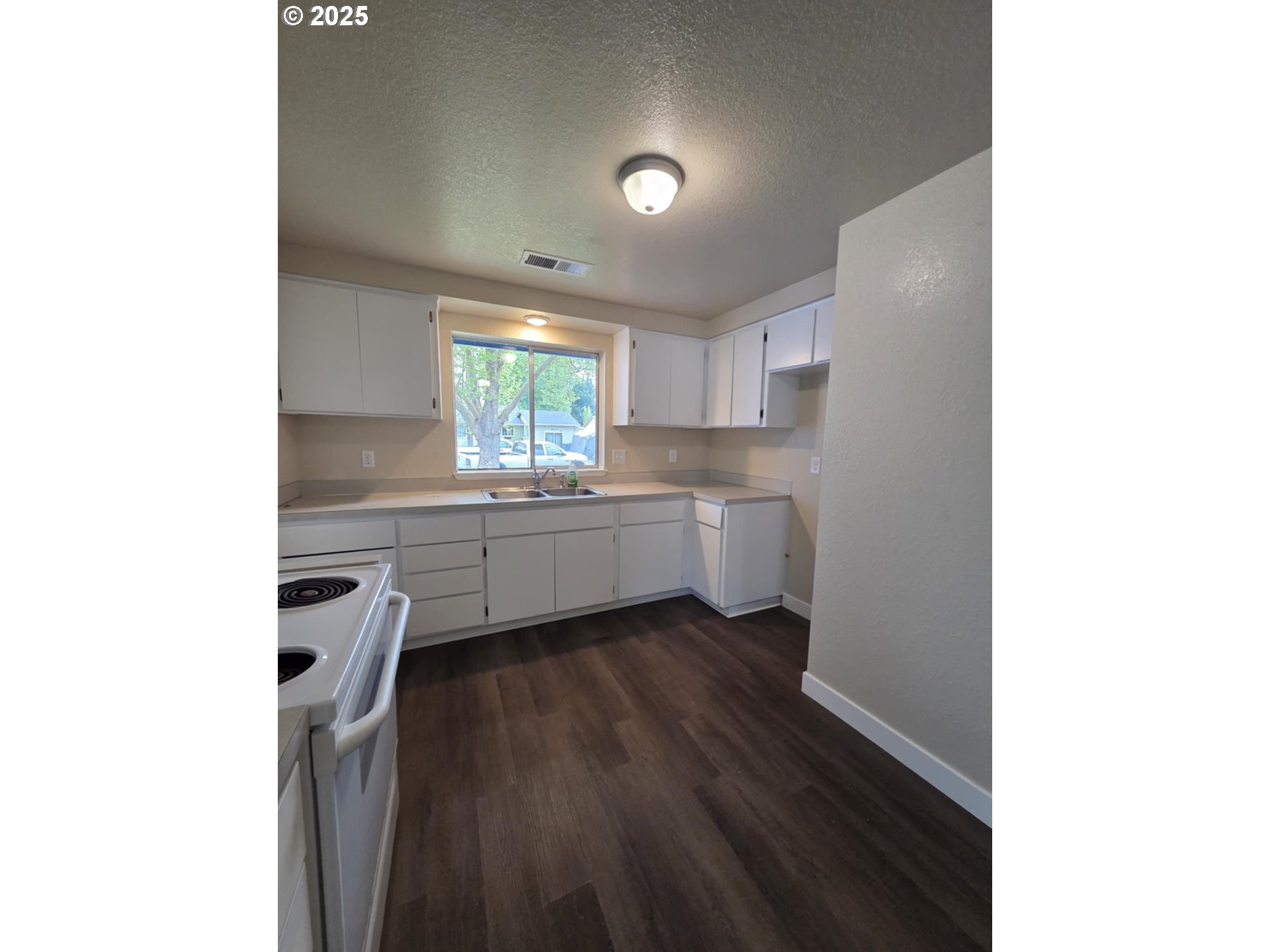 232 Columbia Loop Road Roseburg, OR 97471 - Photo 14 of 19 a kitchen with a sink a window and cabinets