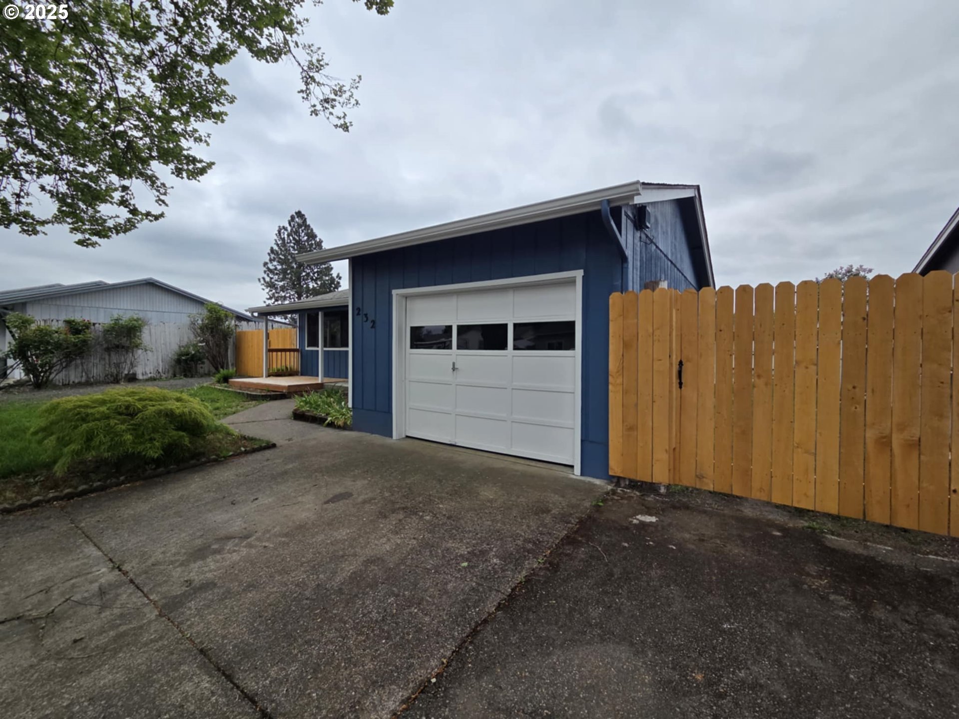 232 Columbia Loop Road Roseburg, OR 97471 - Photo 8 of 19 a front view of a house with a yard and garage