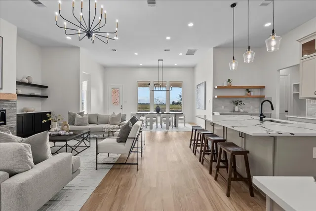 a living room with fireplace furniture and a wooden floor