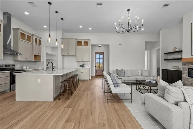 a large white kitchen with stainless steel appliances