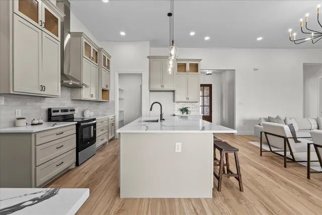 a kitchen with stainless steel appliances granite countertop a sink stove and refrigerator