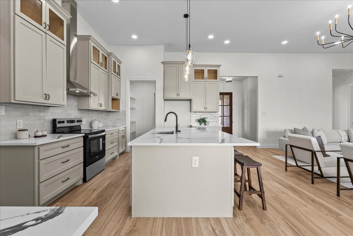 224 Cripple Creek Lane Angleton, TX 77515 - Photo 12 of 38 a kitchen with stainless steel appliances granite countertop a sink stove and refrigerator