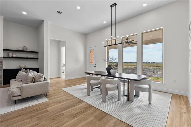 a kitchen with stainless steel appliances white cabinets and a stove top oven