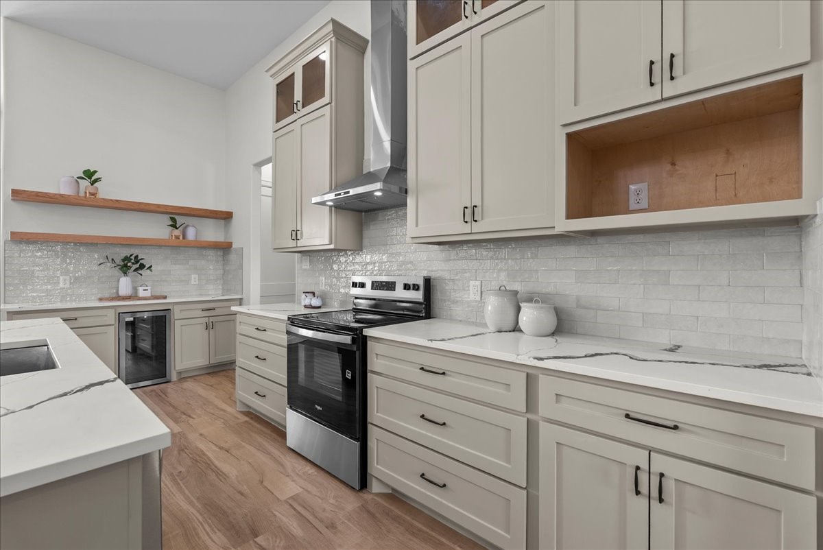 224 Cripple Creek Lane Angleton, TX 77515 - Photo 17 of 38 a kitchen with stainless steel appliances white cabinets and a stove top oven