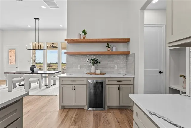 a kitchen with stainless steel appliances granite countertop a lot of counter space and wooden floors