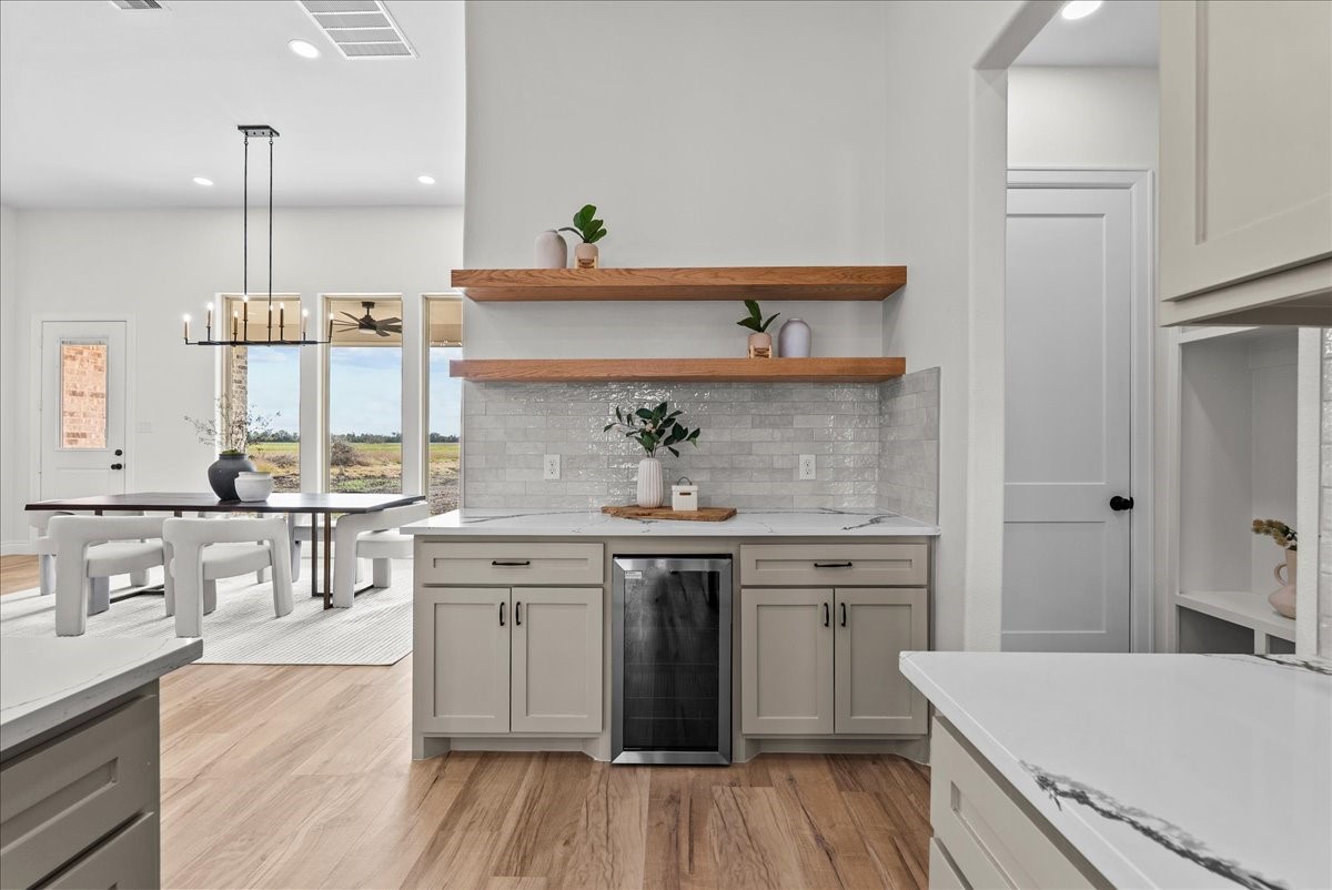 224 Cripple Creek Lane Angleton, TX 77515 - Photo 19 of 38 a kitchen with a sink a stove cabinets and wooden floor
