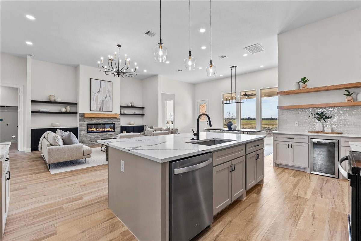 224 Cripple Creek Lane Angleton, TX 77515 - Photo 20 of 38 a kitchen with stainless steel appliances granite countertop a lot of counter space and wooden floors