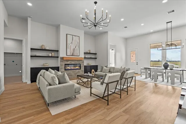 a kitchen with white cabinets and wooden floor