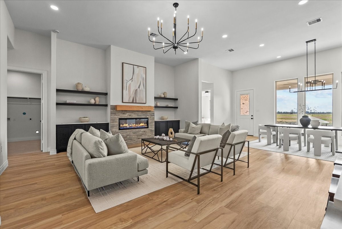 224 Cripple Creek Lane Angleton, TX 77515 - Photo 21 of 38 a living room with fireplace furniture and a wooden floor