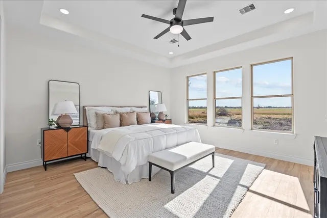 a bedroom with a bed and a painting on the wall
