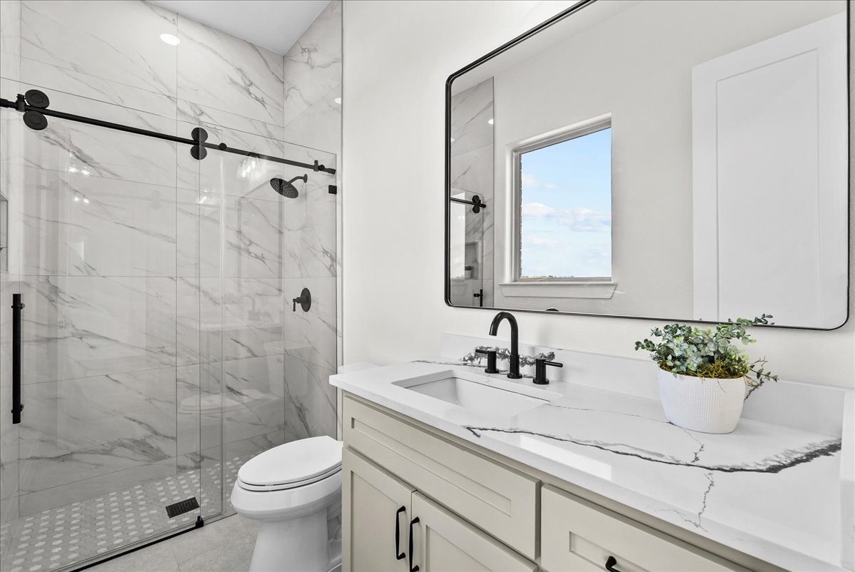 224 Cripple Creek Lane Angleton, TX 77515 - Photo 36 of 38 a bathroom with a sink a toilet and shower