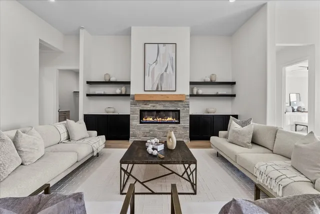 a living room with furniture and a fireplace