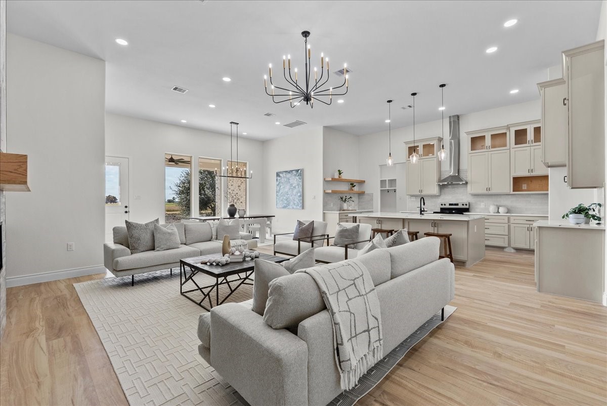 224 Cripple Creek Lane Angleton, TX 77515 - Photo 9 of 38 a living room with furniture kitchen view and a chandelier