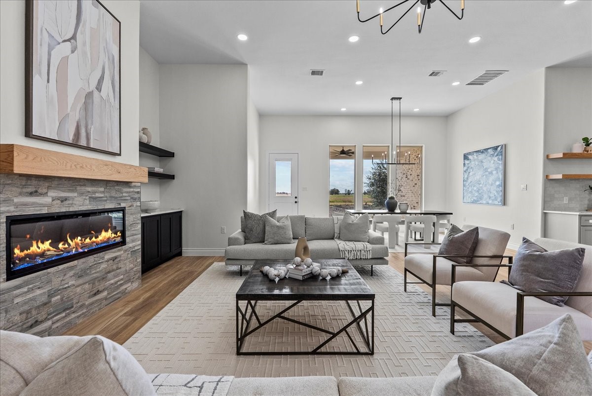 224 Cripple Creek Lane Angleton, TX 77515 - Photo 10 of 38 a living room with furniture and a fireplace