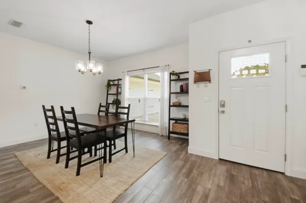 a view of a dining room with furniture and wooden floor