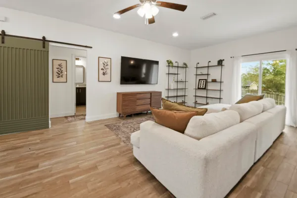 a living room with furniture and a flat screen tv