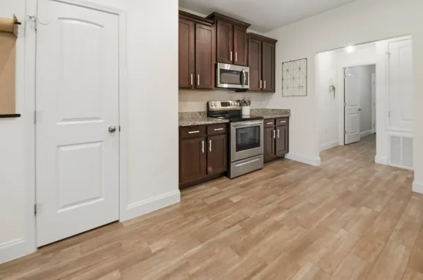 a kitchen with stainless steel appliances granite countertop a stove a sink and a refrigerator