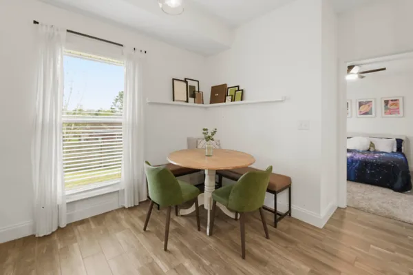 a dining room with furniture and wooden floor