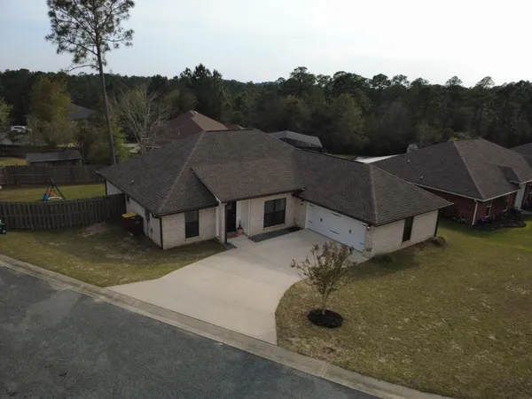 a aerial view of a house with a yard