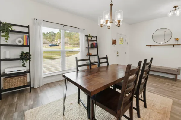 a view of a dining room with furniture window and wooden floor