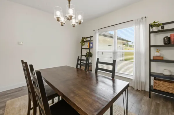 a view of a dining room with furniture and wooden floor