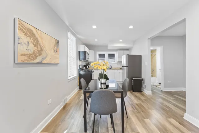 a view of a workspace with furniture and wooden floor