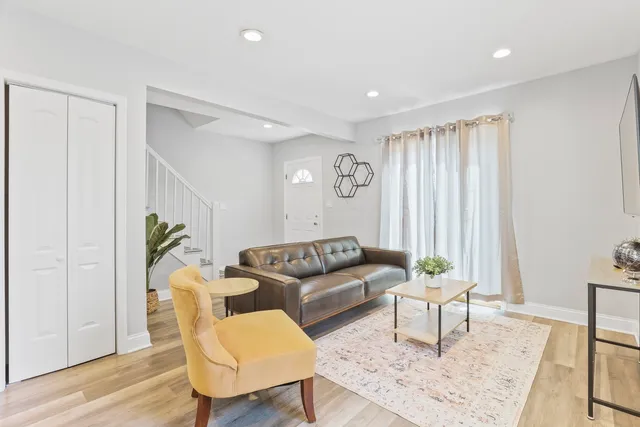 a living room with furniture and a potted plant