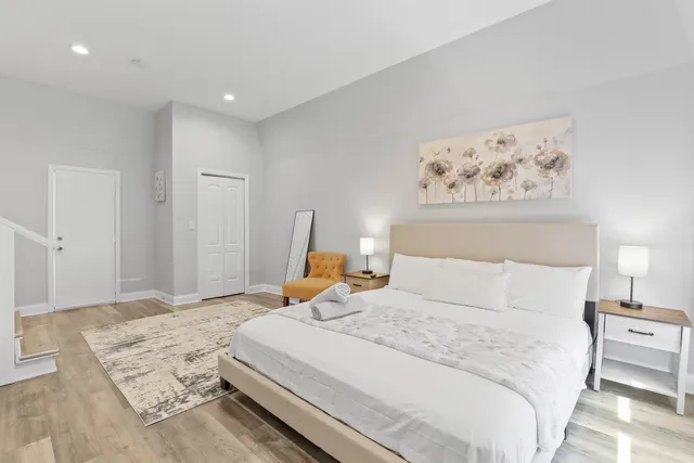 a bedroom with a bed and a painting on the wall