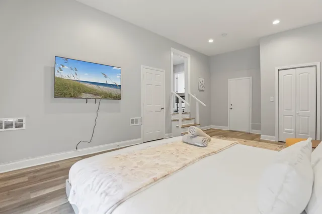 a bedroom with a bed and a painting on the wall