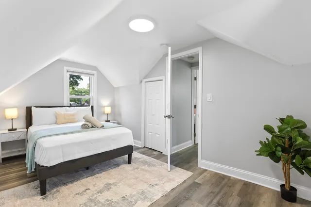 a bedroom with a bed and a potted plant