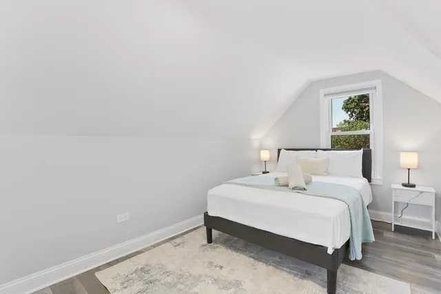 a bedroom with a bed and a lamp