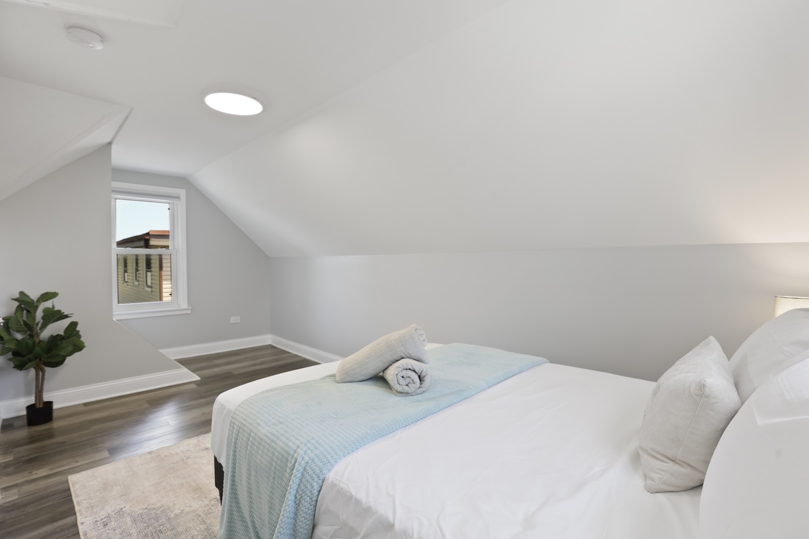 2446 North 1st Avenue River Grove, IL 60171 - Photo 9 of 31 a bedroom with a bed and a potted plant