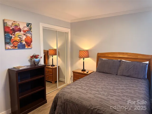 a bedroom with a bed and dresser with mirror