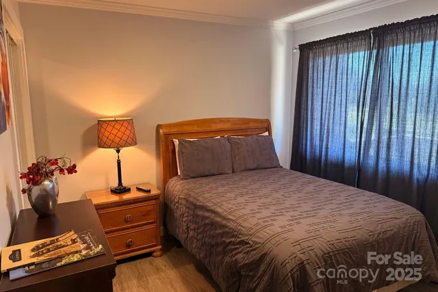 a bedroom with a bed window and a balcony