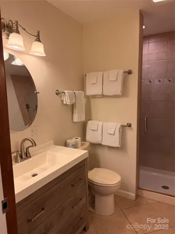 a bathroom with a toilet a sink and a mirror